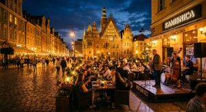 A vibrant, atmospheric evening shot of a cozy Wrocław Market Square restaurant terrace featuring a l