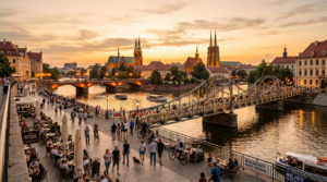 A professional, wide-angle editorial photograph of the Wrocław riverside at golden hour, capturing s
